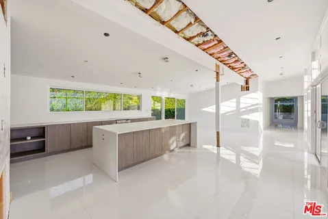 a view of a livingroom with a hall and wooden floor