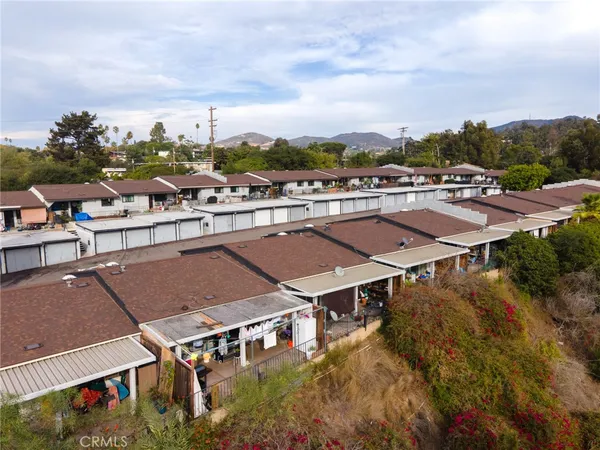 a view of a house with pool and chairs