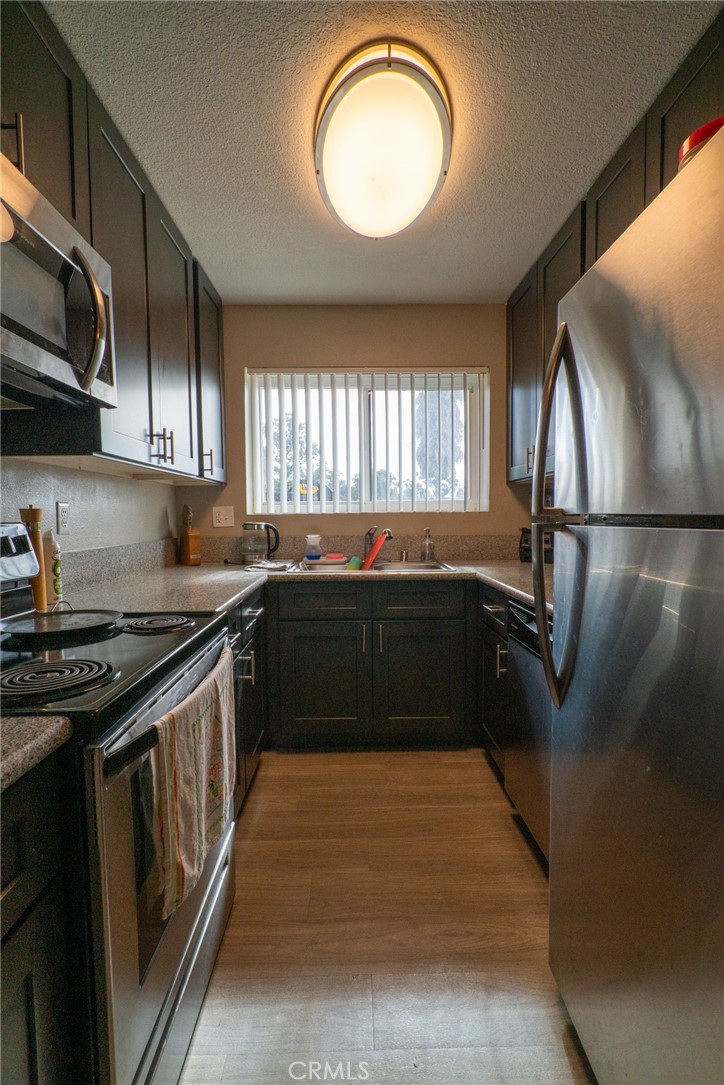 1010 Clearbrook Lane Vista, CA 92084 - Photo 17 of 23 a kitchen with granite countertop a stove and a sink