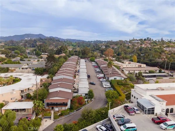 an aerial view of residential houses with outdoor space