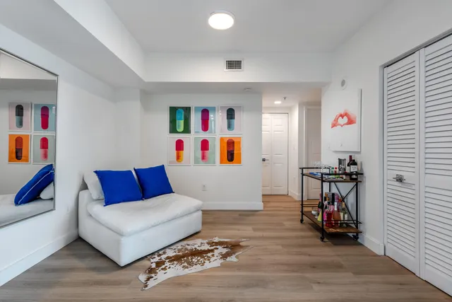 a living room with furniture and a book shelf