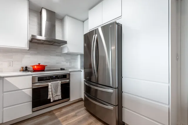 a kitchen with cabinets and stainless steel appliances