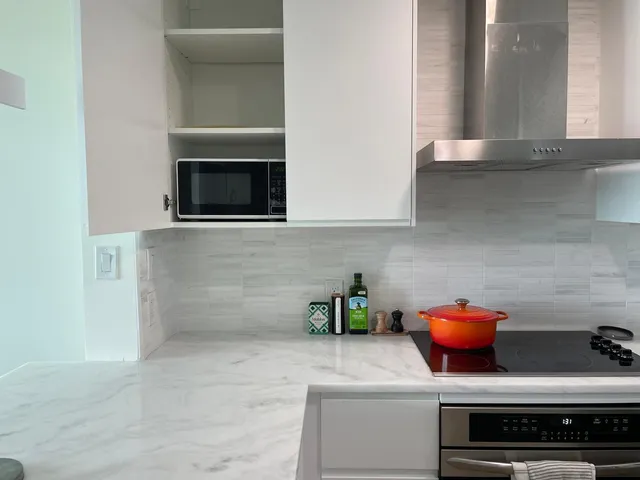 a kitchen with stainless steel appliances a stove and a microwave