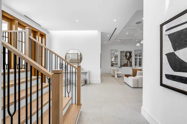 a view of a room with wooden floor ceiling fan and windows