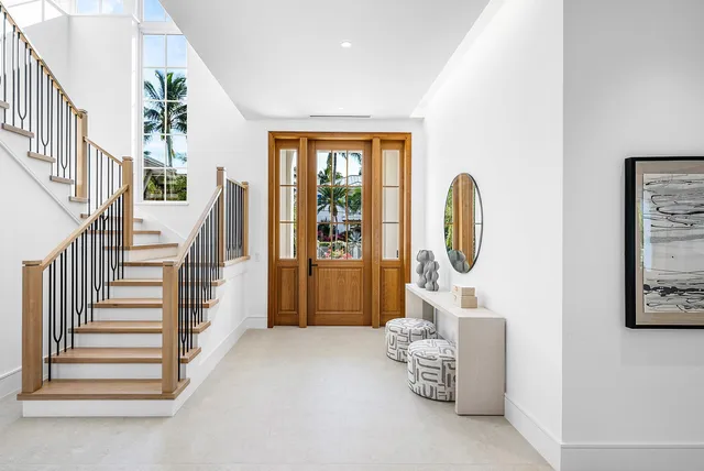 a large kitchen with kitchen island a large window in it
