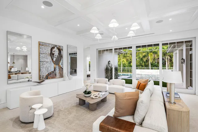 a living room with furniture and kitchen view