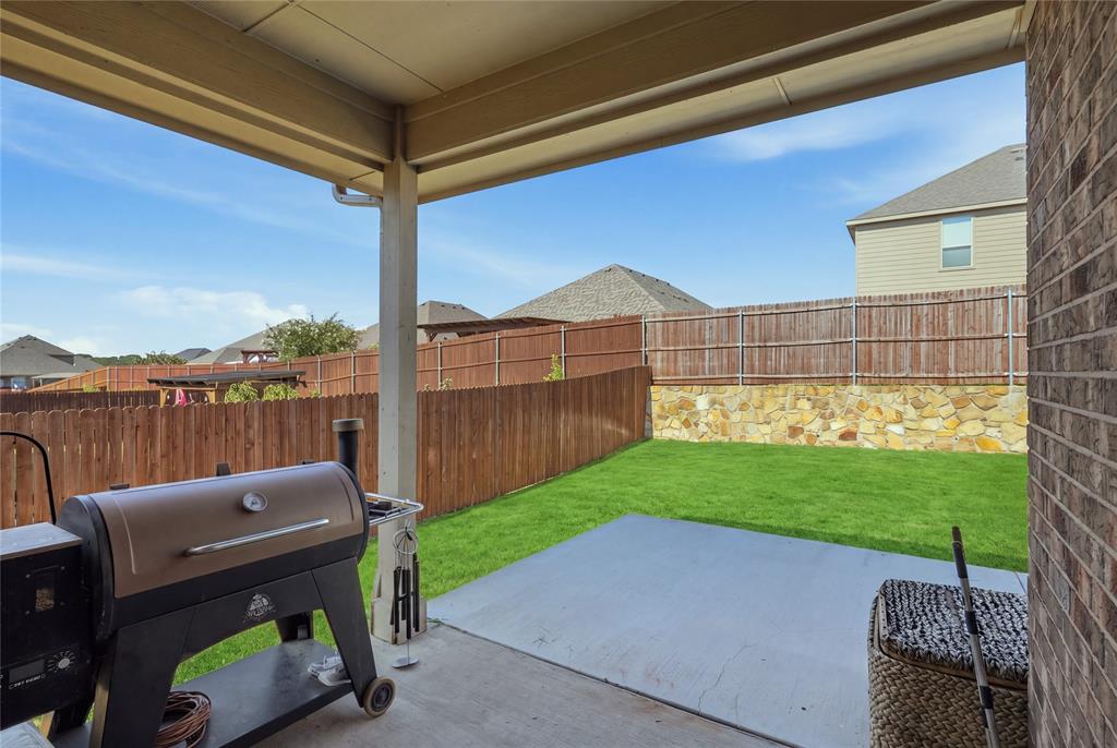 1812 Ruffian Road Granbury, TX 76049 - Photo 33 of 37 Covered patio featuring a concrete slab and brick exterior