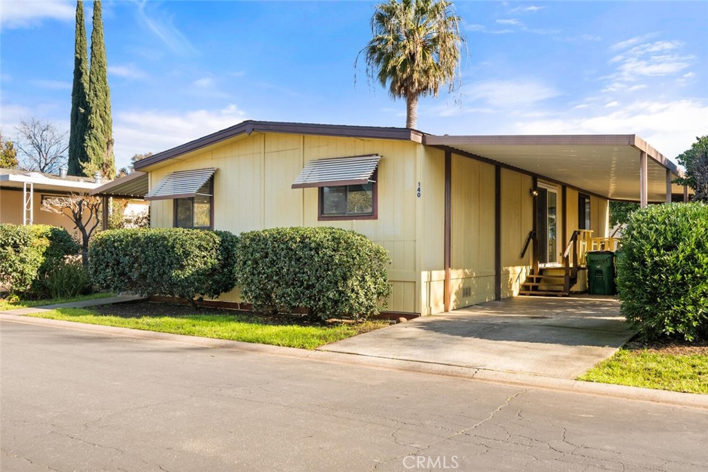 a view of a house with a swimming pool and a yard