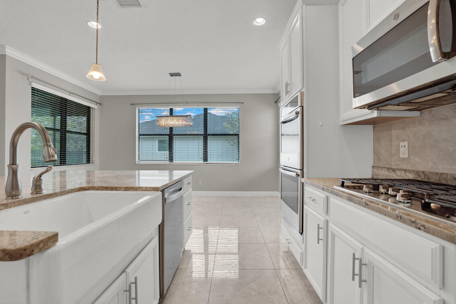 19739 Wheelbarrow Bend Loxahatchee, FL 33470 - Photo 15 of 57 a kitchen with stainless steel appliances granite countertop a sink and a stove