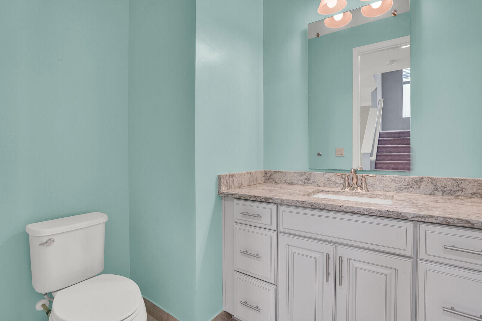19739 Wheelbarrow Bend Loxahatchee, FL 33470 - Photo 20 of 57 a bathroom with a granite countertop toilet sink and mirror