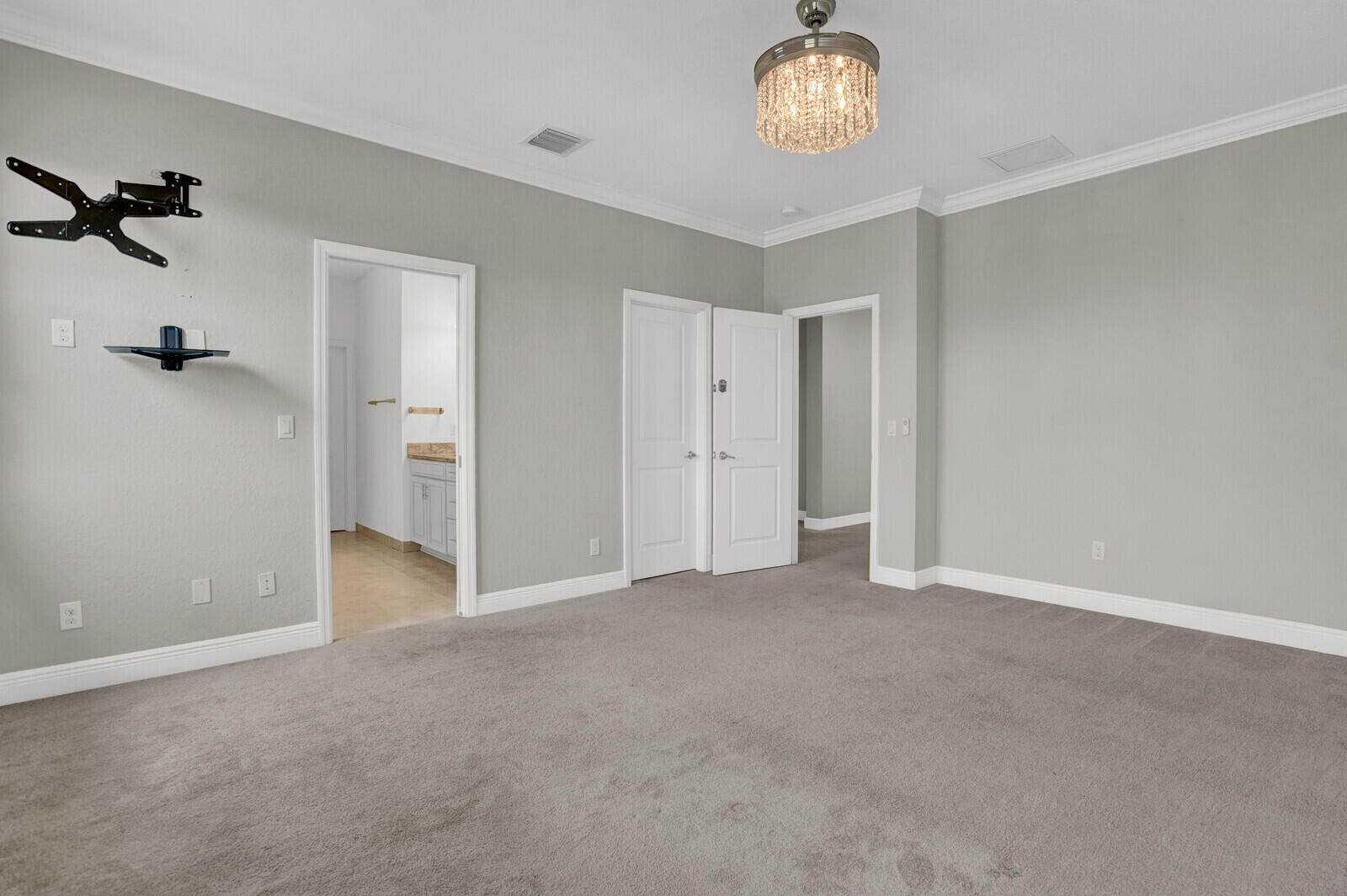 19739 Wheelbarrow Bend Loxahatchee, FL 33470 - Photo 25 of 57 an empty room with a chandelier fan and wooden floor