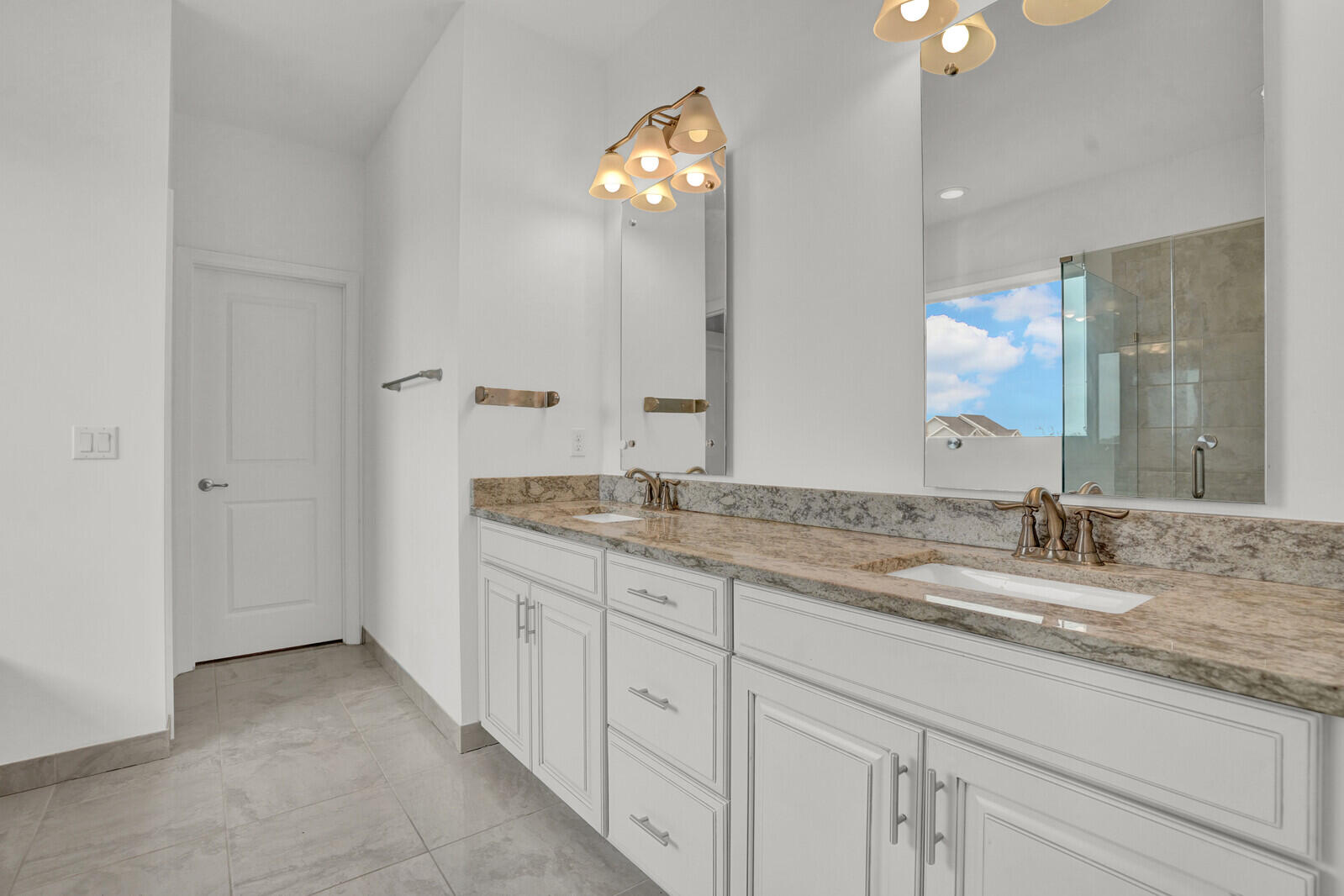 19739 Wheelbarrow Bend Loxahatchee, FL 33470 - Photo 27 of 57 a bathroom with double sink and a mirror