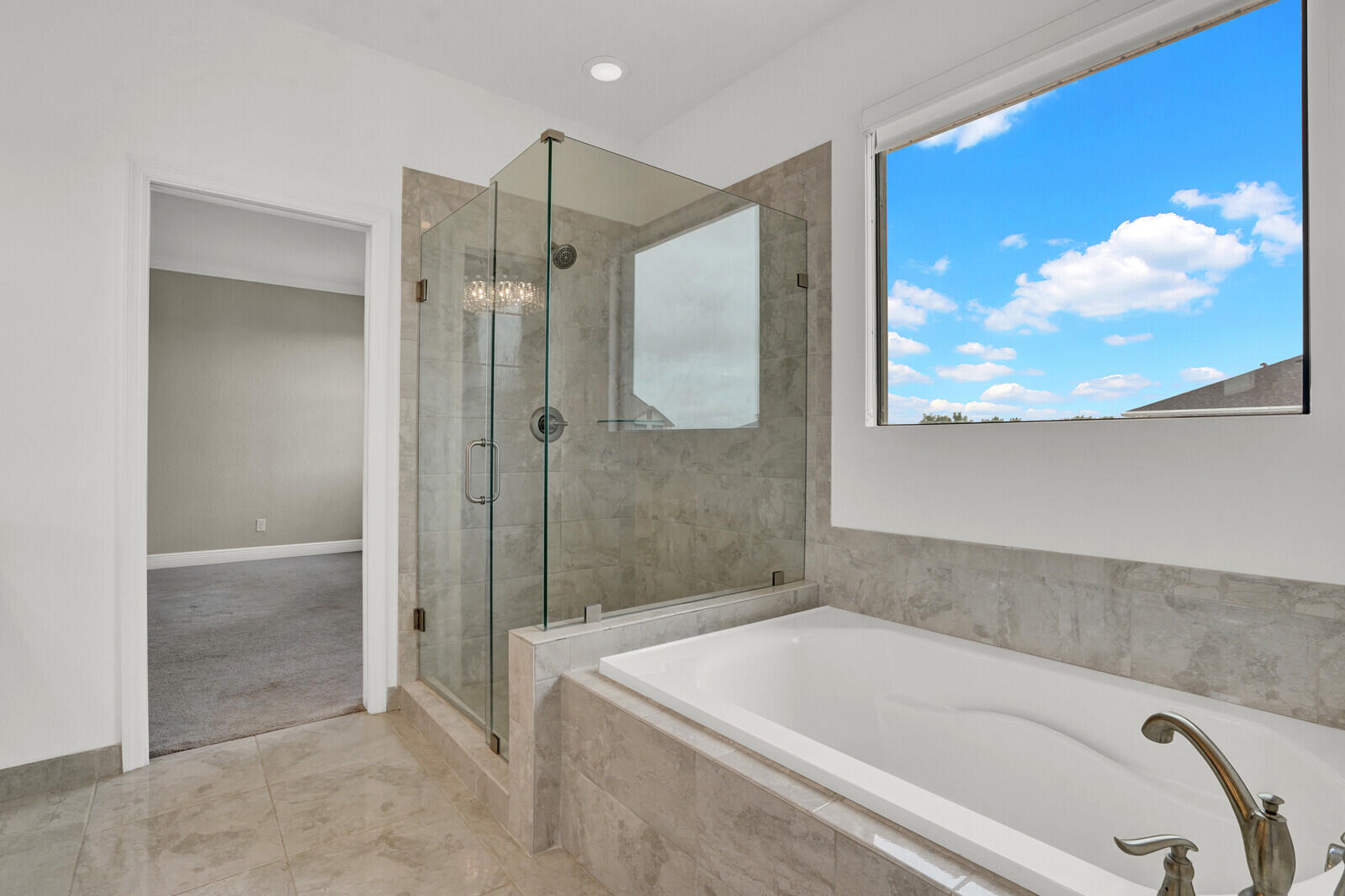 19739 Wheelbarrow Bend Loxahatchee, FL 33470 - Photo 29 of 57 a bathroom with a tub and a shower