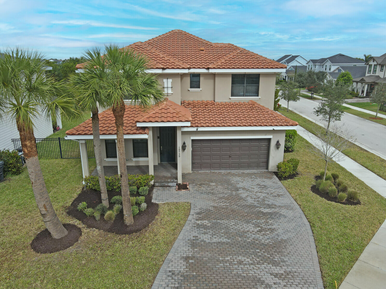 19739 Wheelbarrow Bend Loxahatchee, FL 33470 - Photo 3 of 57 a front view of a house with garden