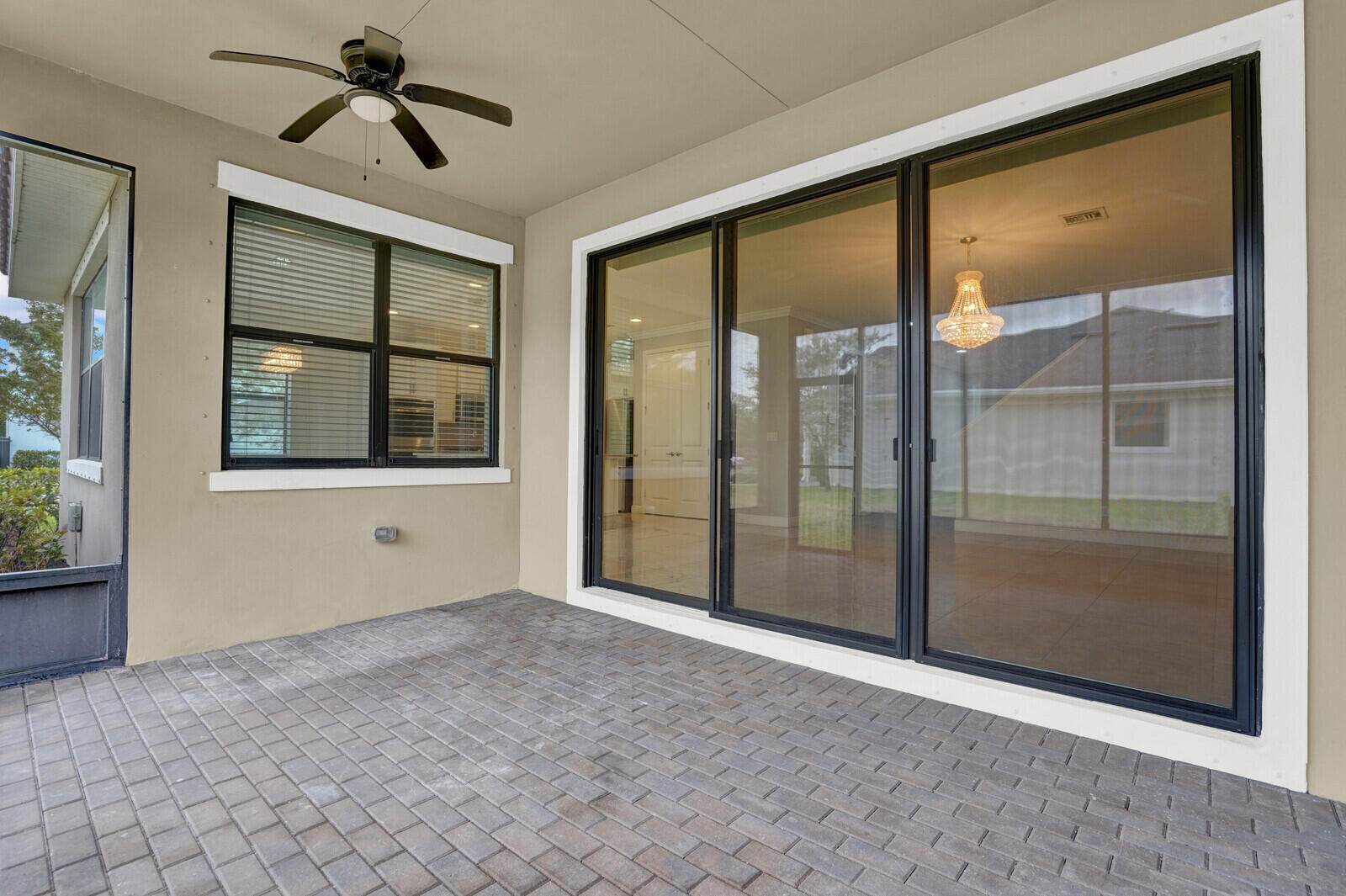 19739 Wheelbarrow Bend Loxahatchee, FL 33470 - Photo 42 of 57 a view of empty room with windows and chandelier