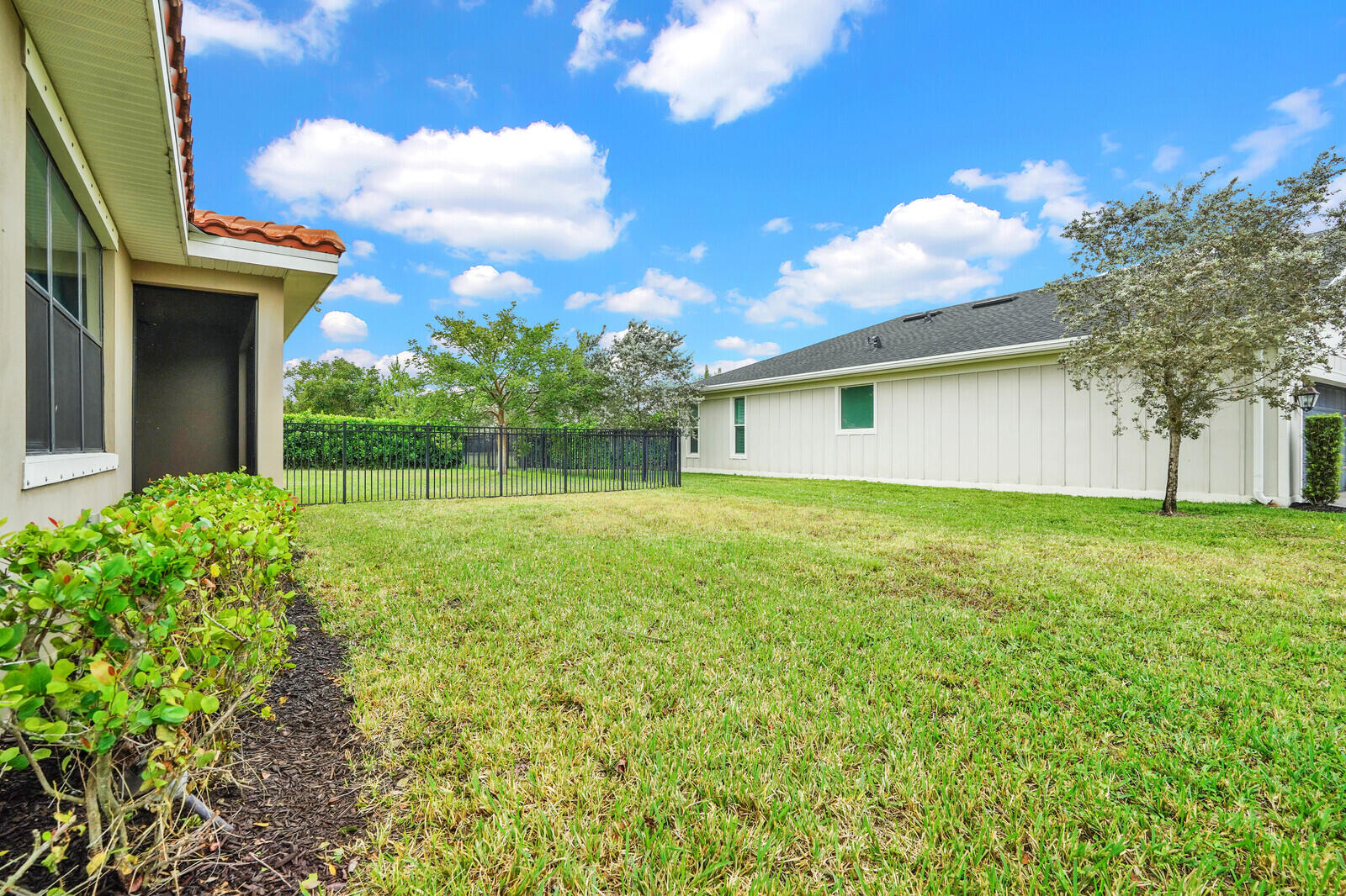 19739 Wheelbarrow Bend Loxahatchee, FL 33470 - Photo 44 of 57 a front view of house with yard and green space