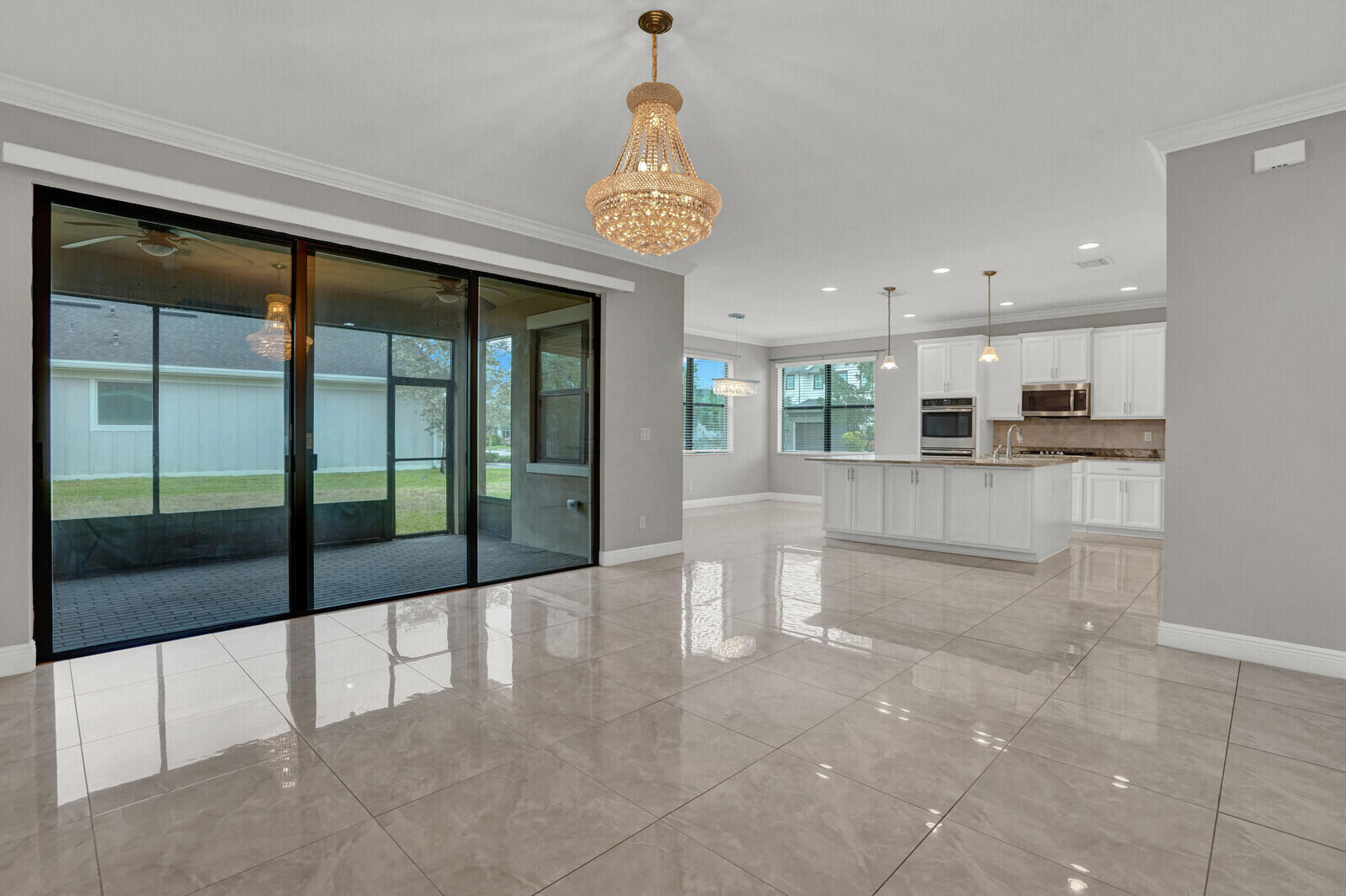 19739 Wheelbarrow Bend Loxahatchee, FL 33470 - Photo 6 of 57 a view of a kitchen with kitchen island and stainless steel appliances