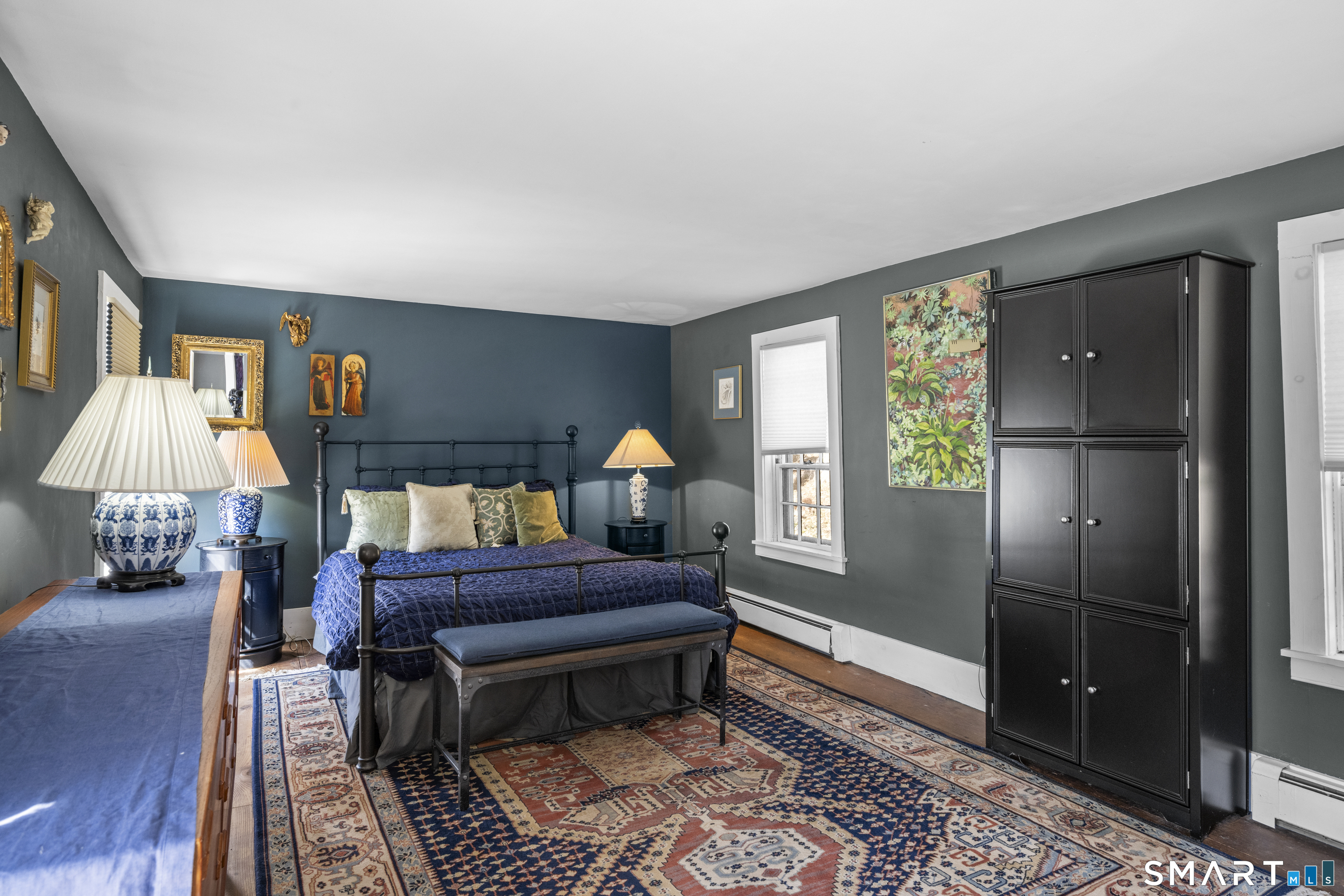 371 Washington Street Norwich, CT 06360 - Photo 17 of 38 a bed room with a bed and a lamp
