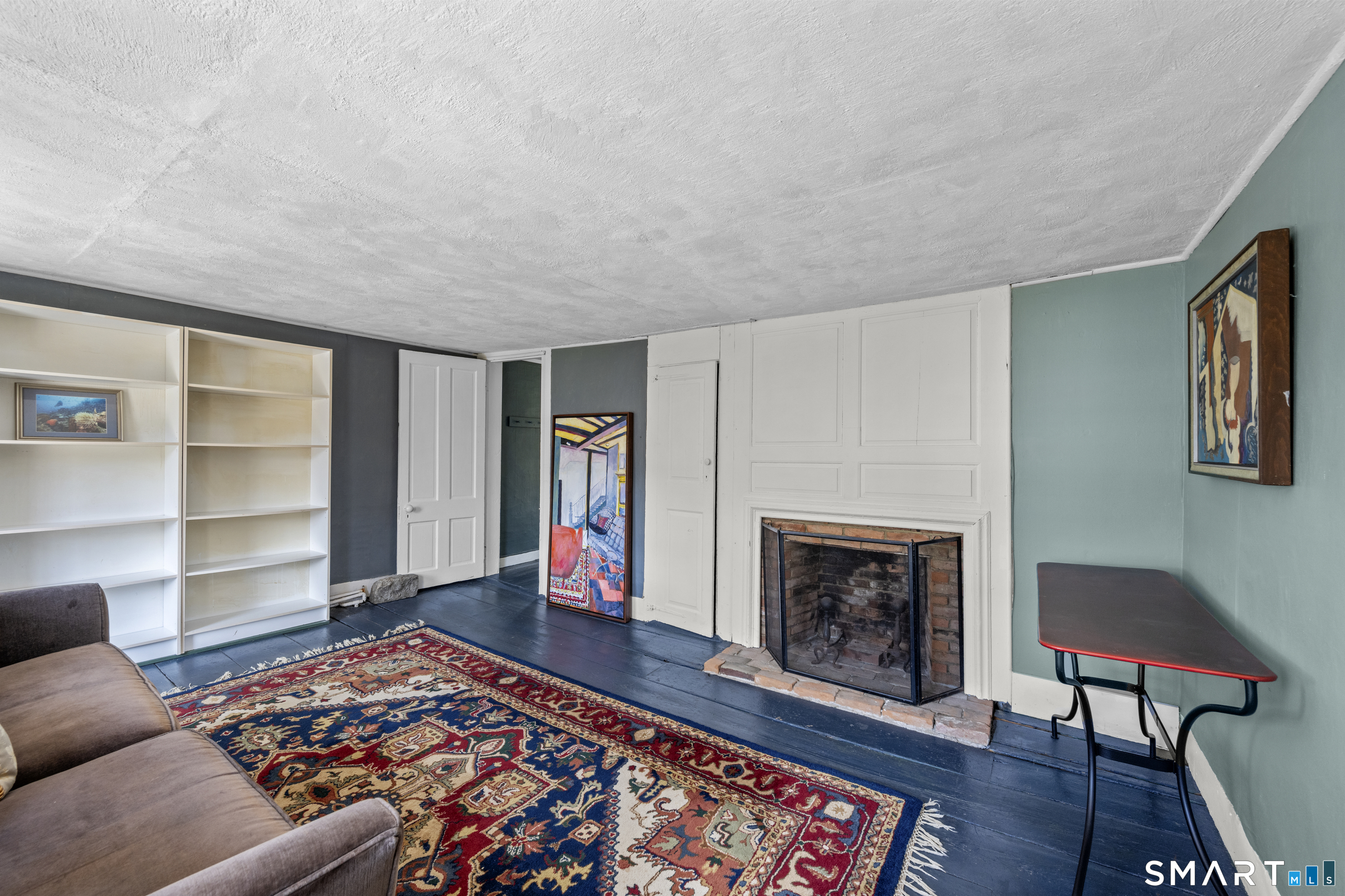 371 Washington Street Norwich, CT 06360 - Photo 22 of 38 a living room with furniture and a fireplace