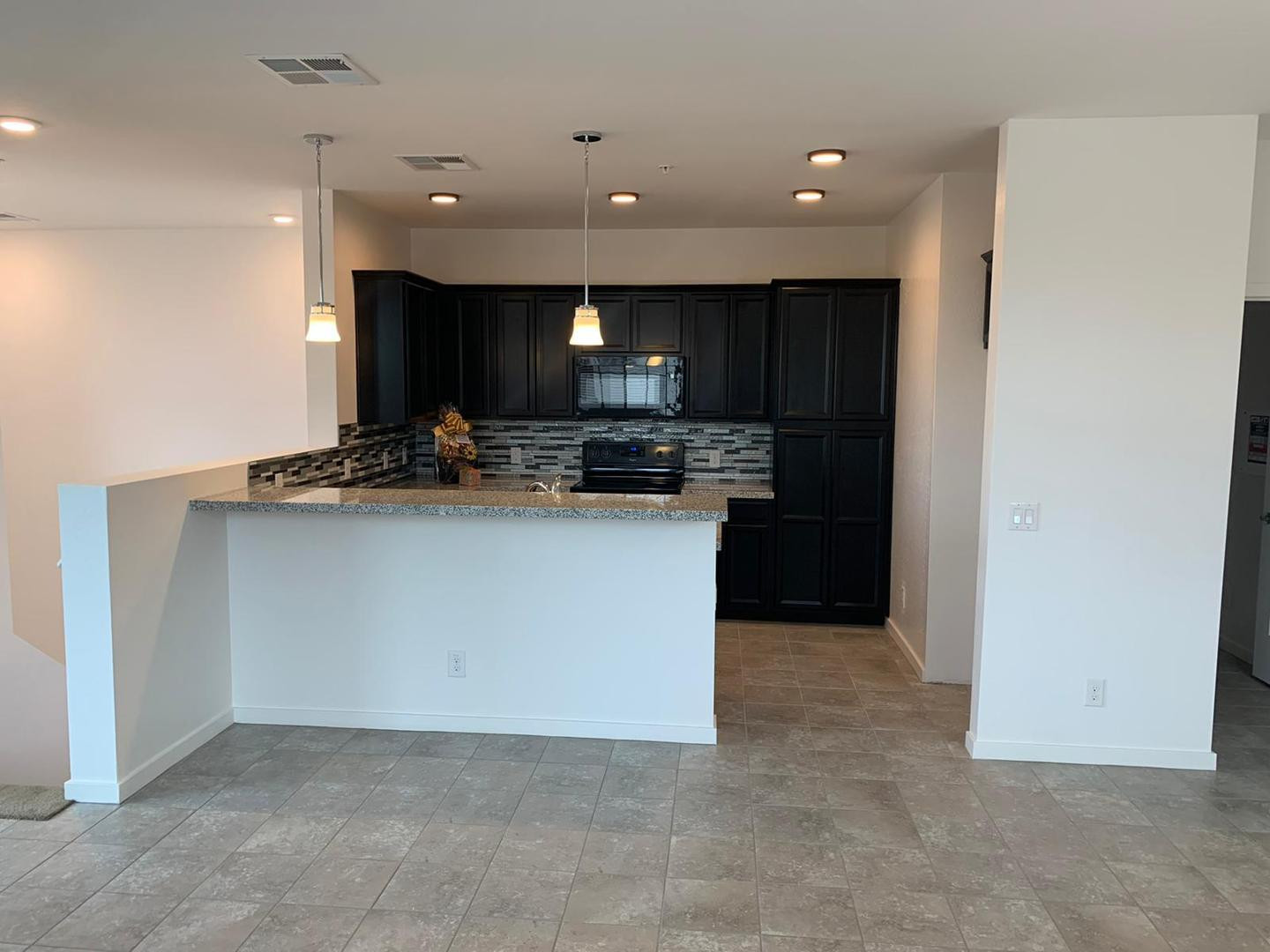 3900 East Baseline Road, Unit 118 Phoenix, AZ 85042 - Photo 19 of 32 a kitchen with stainless steel appliances granite countertop a stove and a sink
