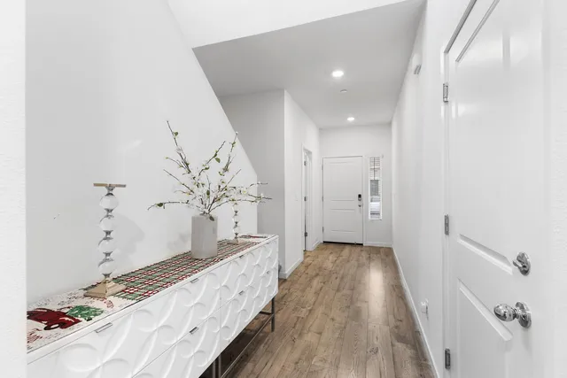 a view of hallway with wooden floor