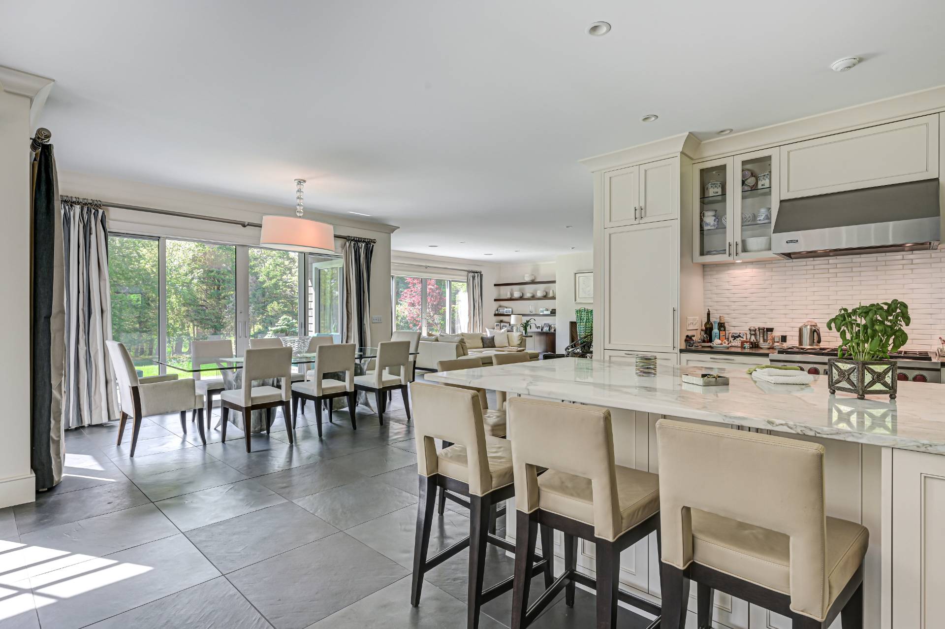 Undisclosed Address Remsenburg, NY 11960 - Photo 12 of 50 a dining hall with stainless steel appliances granite countertop a stove a table and chairs with wooden floor