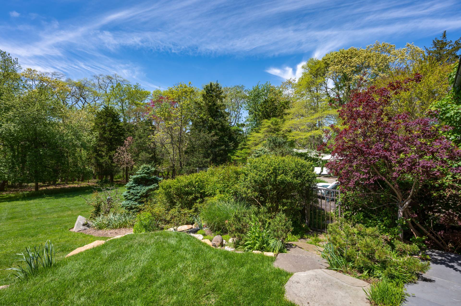 Undisclosed Address Remsenburg, NY 11960 - Photo 40 of 50 a view of a garden with a building in the background
