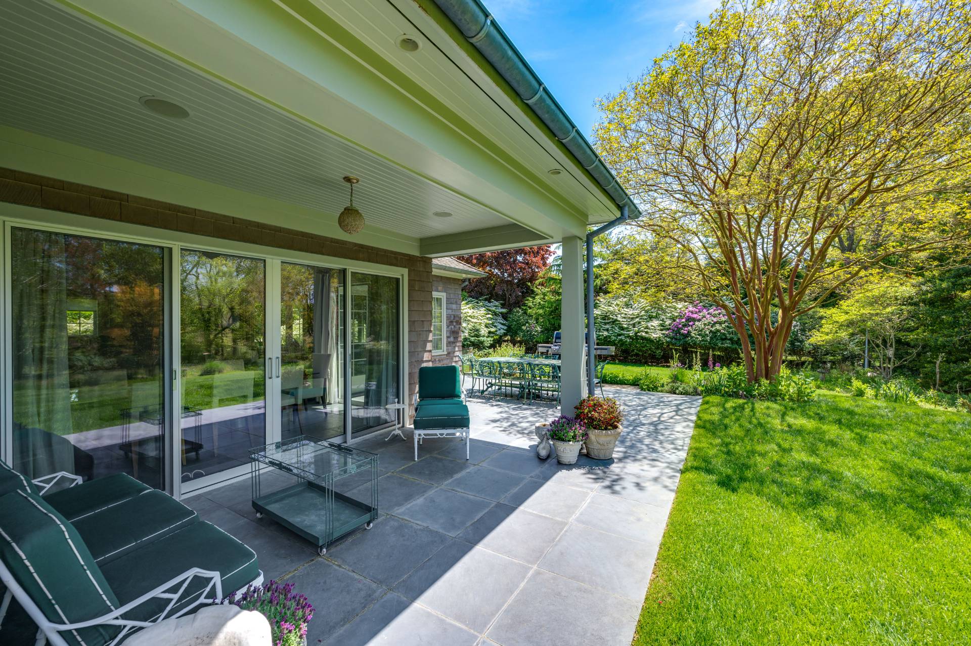 Undisclosed Address Remsenburg, NY 11960 - Photo 47 of 50 a view of a patio with couches chairs and a big yard