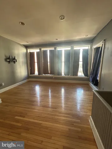 a view of a room with wooden floor