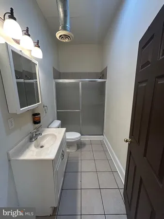 a bathroom with a sink a mirror and a shower