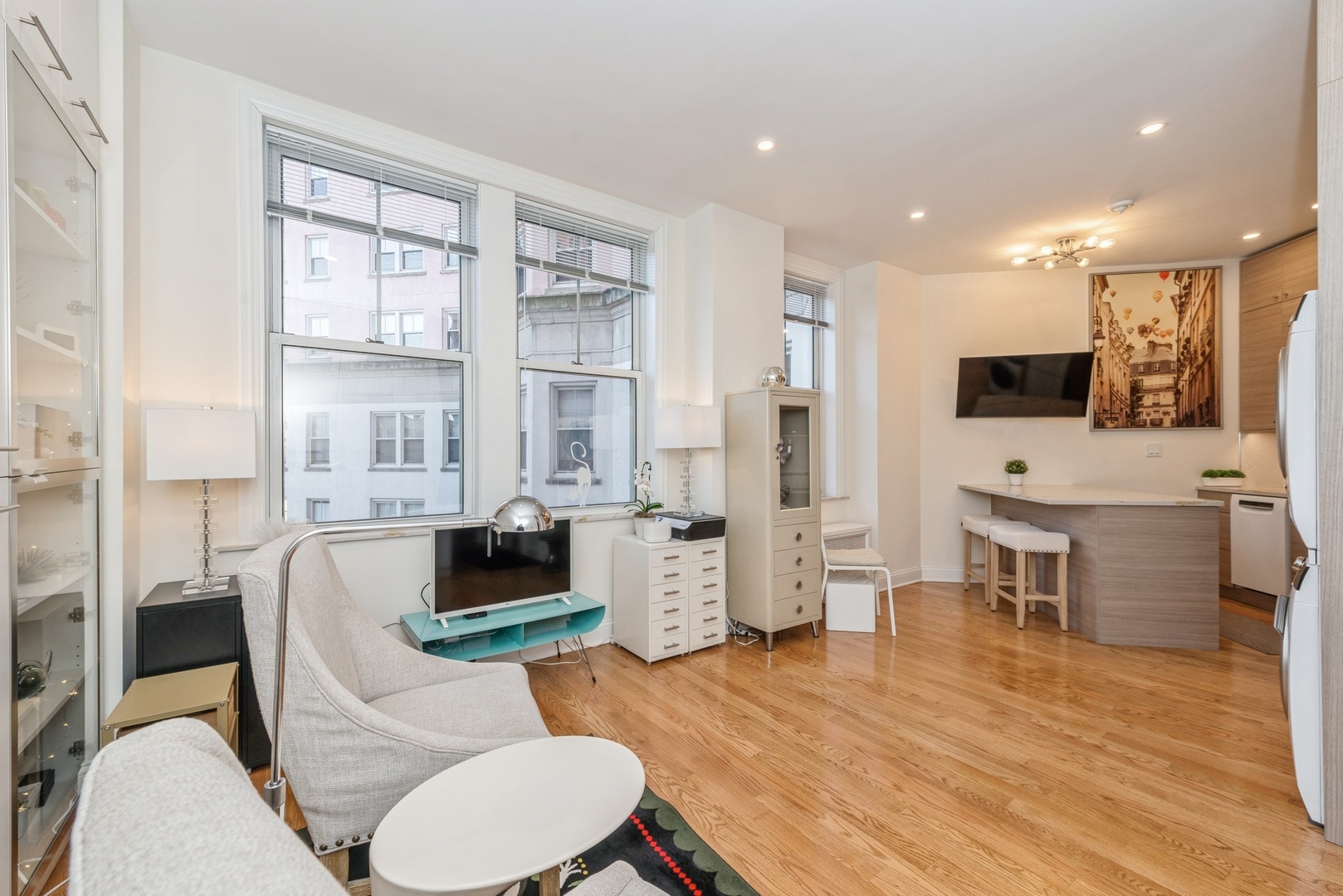 5555 North Sheridan Road, Unit 227 Chicago, IL 60640 - Photo 2 of 23 a living room with furniture and a flat screen tv