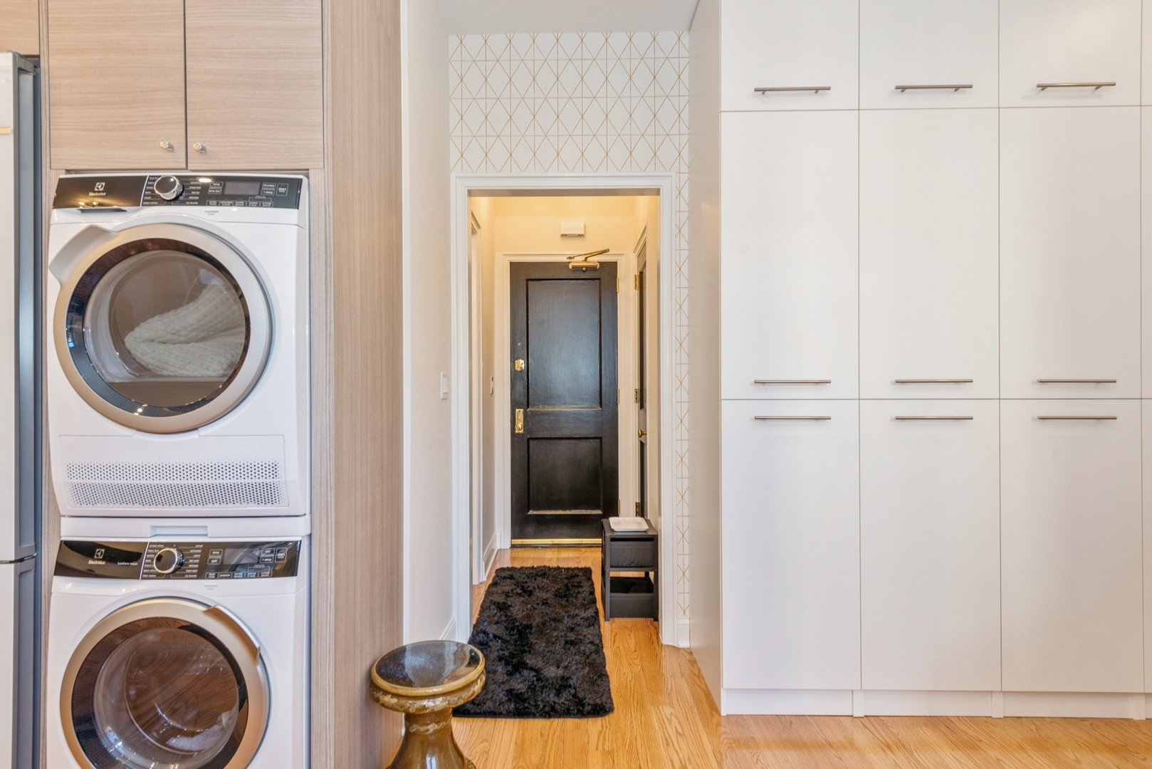 5555 North Sheridan Road, Unit 227 Chicago, IL 60640 - Photo 3 of 23 a view of a hallway with washer and dryer