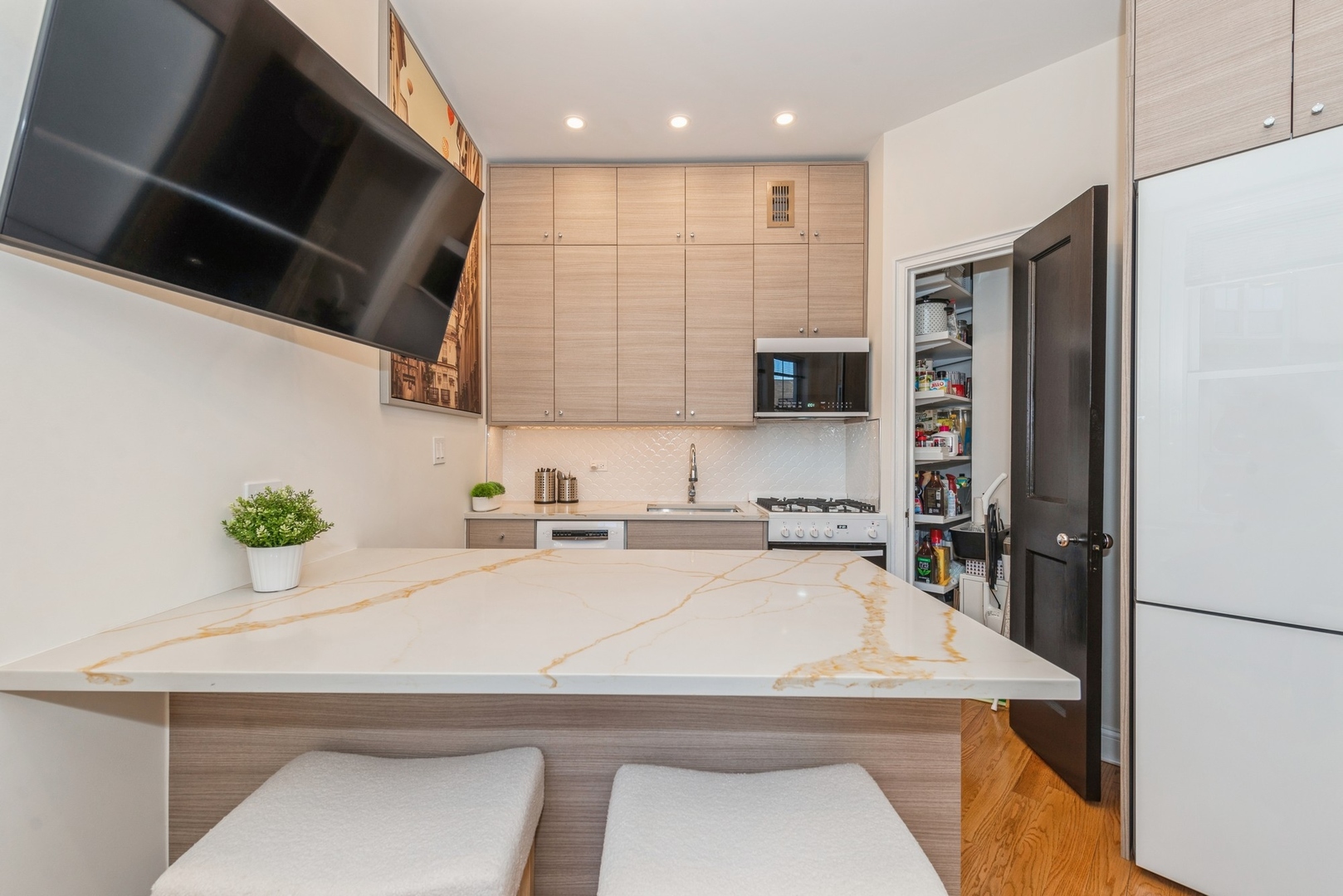 5555 North Sheridan Road, Unit 227 Chicago, IL 60640 - Photo 8 of 23 a kitchen with a sink a refrigerator and a stove top oven