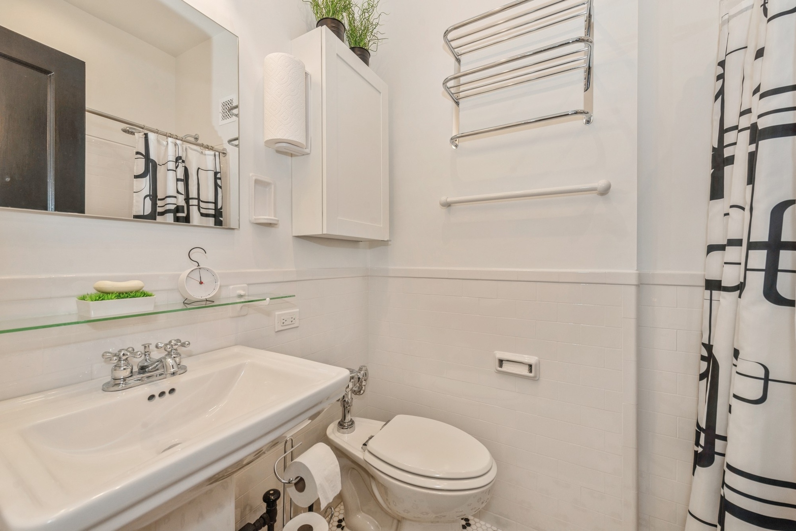 5555 North Sheridan Road, Unit 227 Chicago, IL 60640 - Photo 10 of 23 a bathroom with a sink a toilet and shower