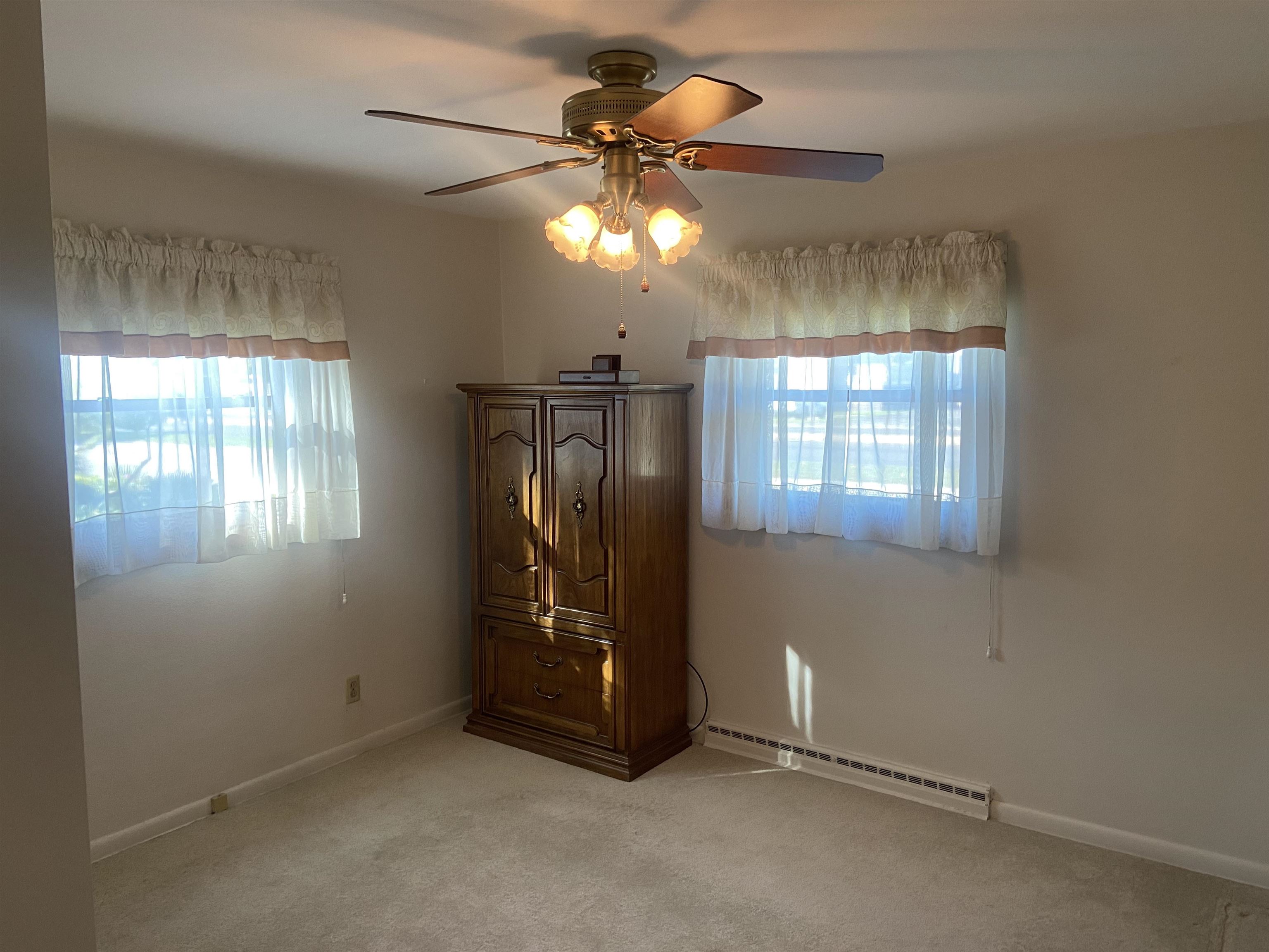 2006 South Alpine Road Rockford, IL 61108 - Photo 11 of 15 an empty room with windows and chandelier fan
