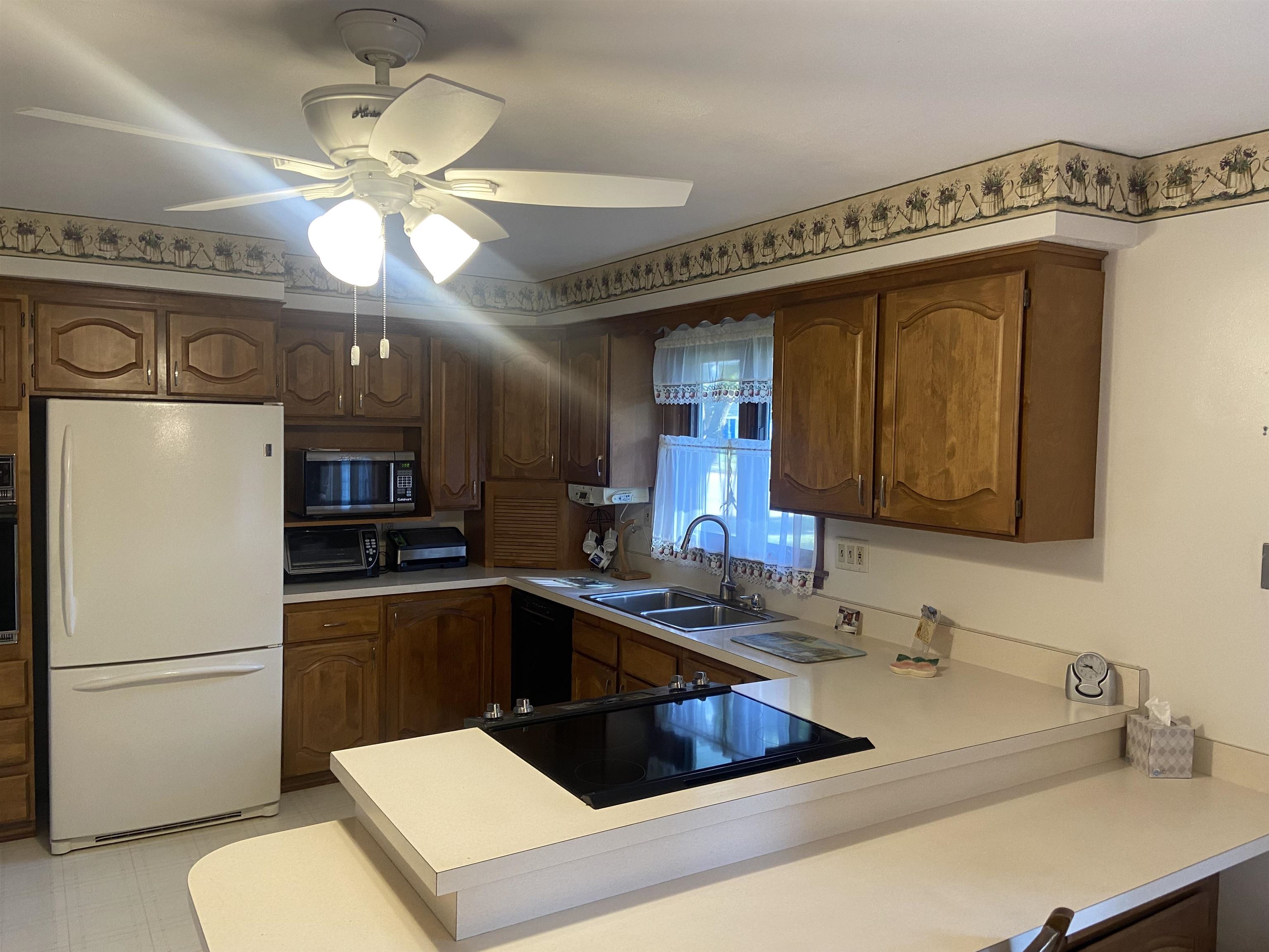 2006 South Alpine Road Rockford, IL 61108 - Photo 8 of 15 a kitchen with a refrigerator a sink and cabinets