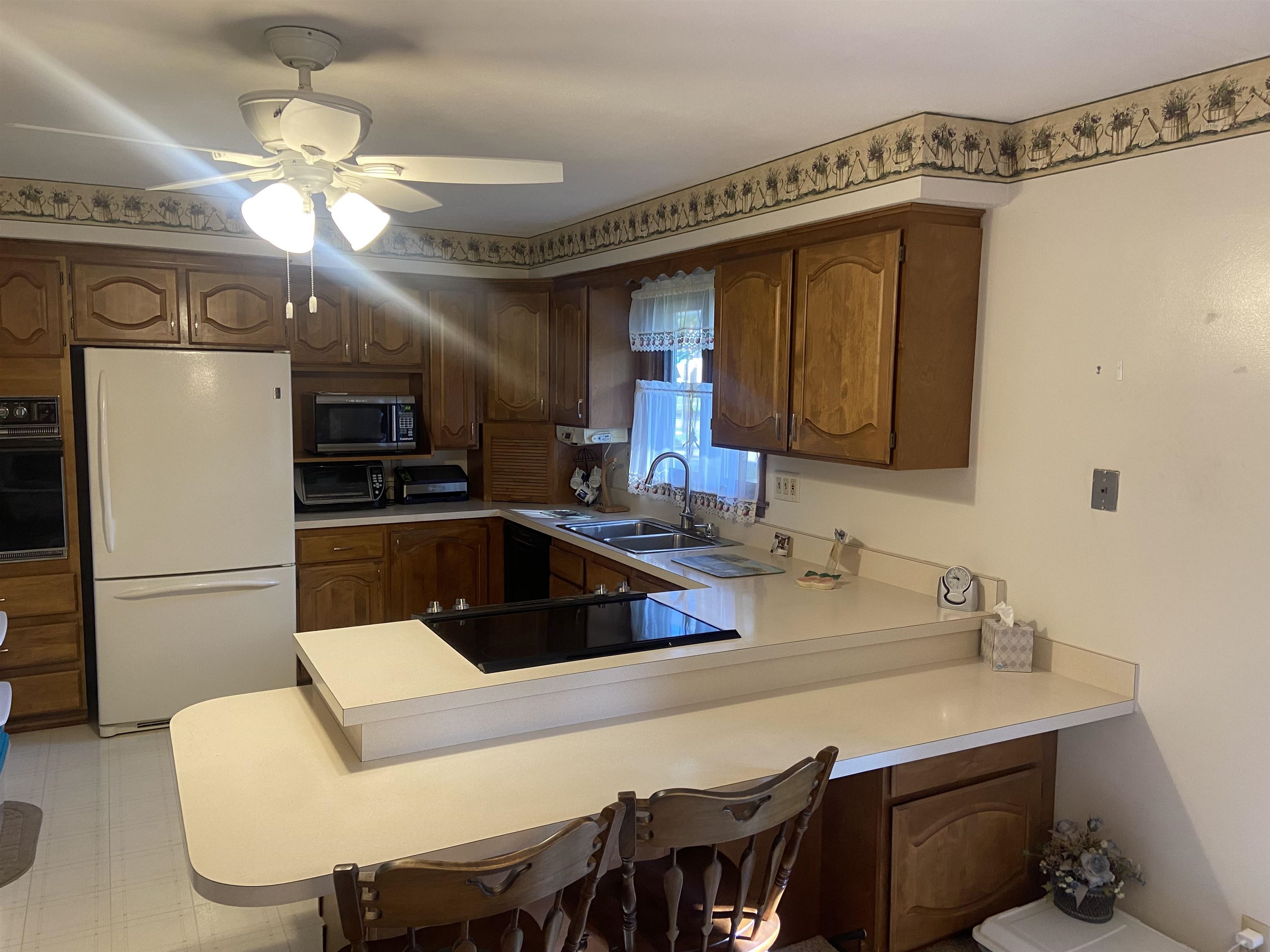 2006 South Alpine Road Rockford, IL 61108 - Photo 9 of 15 a kitchen with a table chairs sink and refrigerator