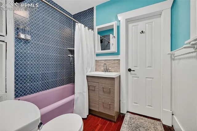 a bathroom with a toilet a sink and bathtub