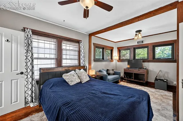 a bedroom with a bed couch and window
