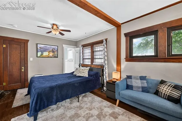 a bedroom with a bed couch and window