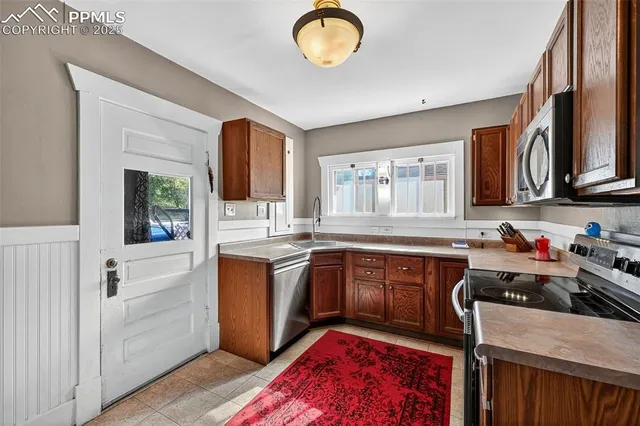 a kitchen with sink cabinets and window