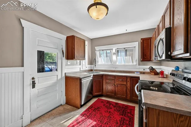 a kitchen with sink cabinets and window