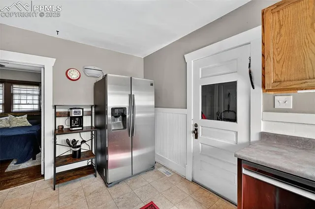 a kitchen with stainless steel appliances granite countertop a refrigerator and a stove