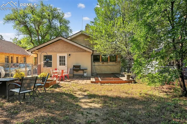 a view of a house with backyard porch and sitting area