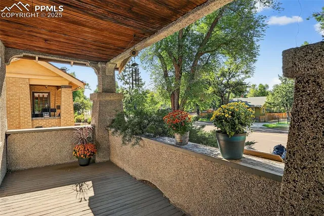 a view of a porch with furniture and a garden
