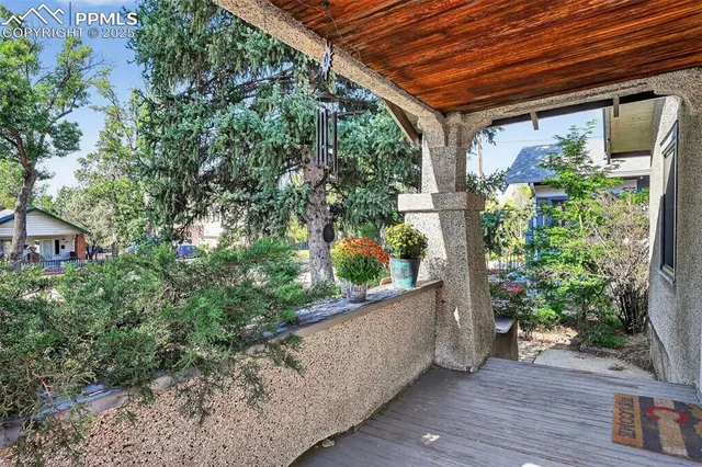 a backyard of a house with plants and outdoor seating