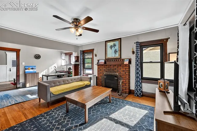 a living room with furniture a fireplace and a flat screen tv