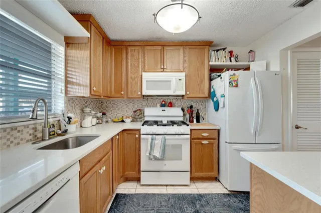 a kitchen with a refrigerator a stove a washer and dryer