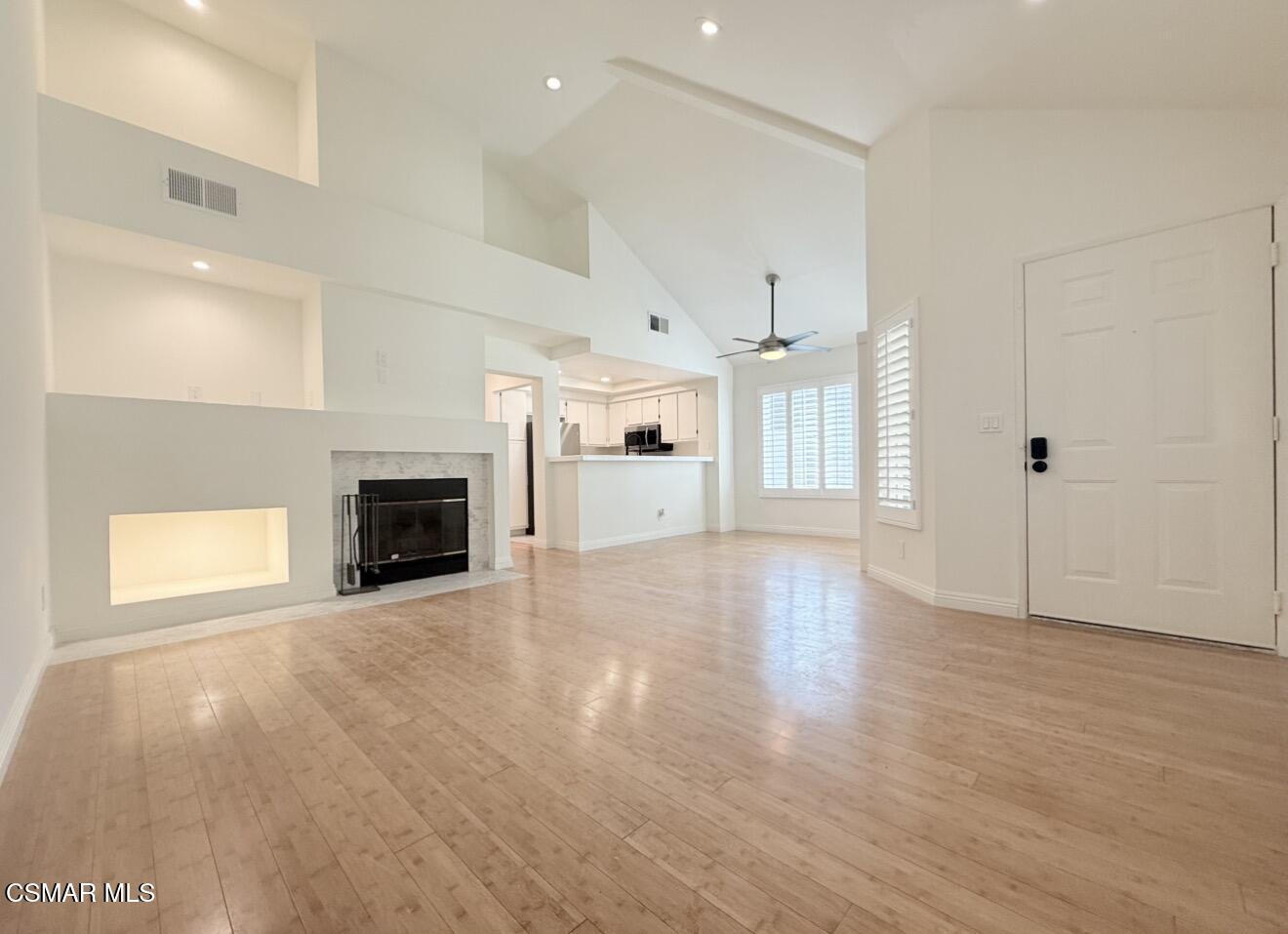 4240 Lost Hills Road, Unit 3107 Agoura Hills, CA 91301 - Photo 5 of 21 an empty room with wooden floor fireplace and windows