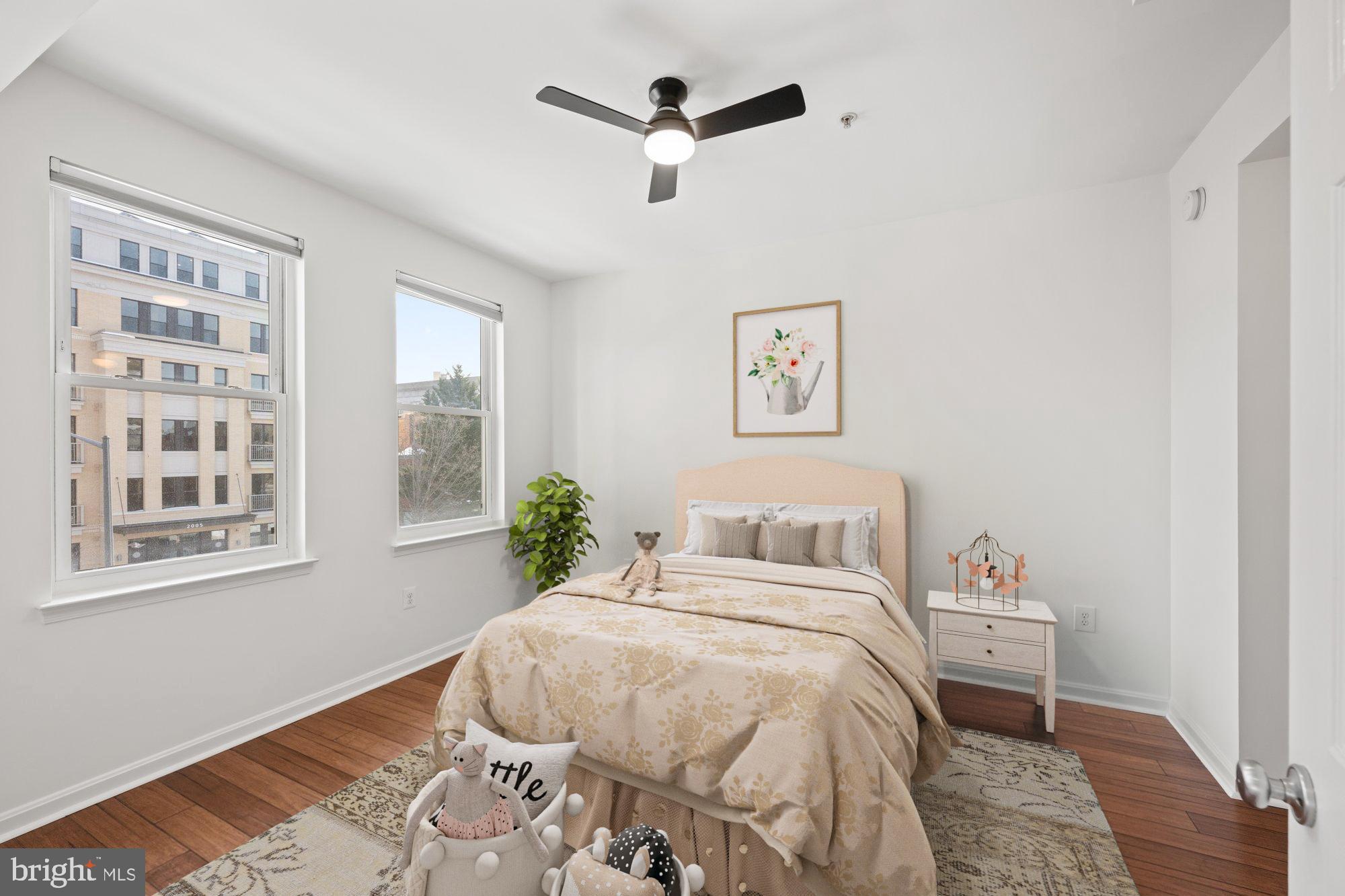 2004 11th Street Northwest, Unit 222 Washington, DC 20001 - Photo 8 of 14 a bedroom with a bed next to a window with a chandelier